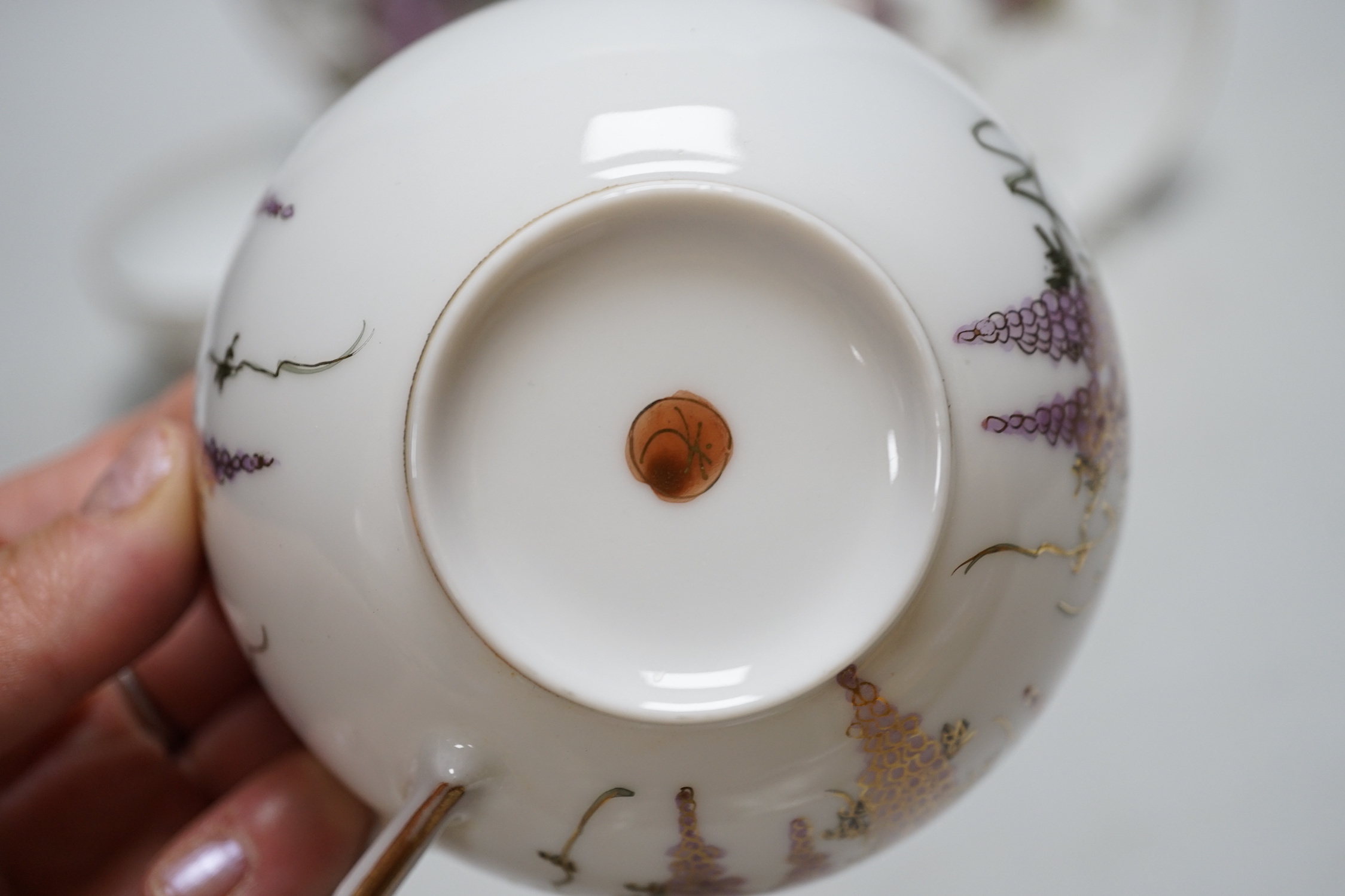 A Japanese eggshell part tea service with wisteria decoration, comprising of eight cups, eleven saucers and twelve tea plates